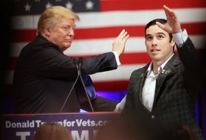 Republican presidential candidate Donald Trump greets retired Army Sgt. 1st Class John Wayne Walding to the stage at a event in support of veterans at Drake University in Des Moines, Iowa, Thursday, Jan. 28, 2016. (AP Photo/Andrew Harnik) ORG XMIT: IAAH419